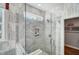 Modern shower with marble tile, glass door, and integrated shelving at 67 Rice Road # 01, Zebulon, NC 27597