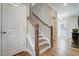 Traditional staircase with wood railing and white risers with light wood floors at 67 Rice Road # 01, Zebulon, NC 27597
