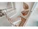 Staircase with light wood treads and white risers adorned with leaf-shaped wall art at 67 Rice Road # 01, Zebulon, NC 27597