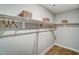 Spacious walk-in closet features wood shelving, baskets for storage, and hanging space at 67 Rice Road # 01, Zebulon, NC 27597