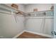 Simple walk-in closet with wooden floors, white shelving, and hanging racks at 67 Rice Road # 01, Zebulon, NC 27597