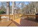 Wooden deck with railings, offering an outdoor space with views of the surrounding trees at 7 Misty Creek Ct, Durham, NC 27705