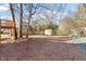 Spacious backyard featuring mature trees, a wooden deck, and shed at 7 Misty Creek Ct, Durham, NC 27705