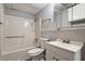 A white bathroom with a tub/shower combo and storage underneath the sink at 7 Misty Creek Ct, Durham, NC 27705