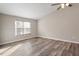Bedroom with modern flooring, neutral walls, and natural light from a large window at 7 Misty Creek Ct, Durham, NC 27705