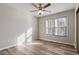 This bedroom features wood-look flooring, a ceiling fan and natural light from a large window at 7 Misty Creek Ct, Durham, NC 27705
