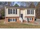 Charming two-story home featuring a brick foundation and classic black shutters at 7 Misty Creek Ct, Durham, NC 27705