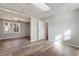 An additional living room with wood-look flooring and an entrance to another room at 7 Misty Creek Ct, Durham, NC 27705