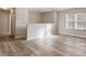 Sunlight streams through the window, illuminating the beautiful hardwood floors in this cozy and inviting living space at 7 Misty Creek Ct, Durham, NC 27705