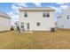 The home's backyard features a grill, bike, sliding glass door, and vinyl siding under a partly cloudy sky at 702 Blue Lake Dr, Mebane, NC 27302