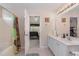 Bathroom showcasing a shower/tub combo, dual sink vanity, and access to the bedroom at 702 Blue Lake Dr, Mebane, NC 27302