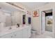 Bright bathroom featuring dual sinks, ample counter space, and a walk-in shower at 702 Blue Lake Dr, Mebane, NC 27302