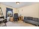 Bright bedroom featuring a workspace, large window with curtains, and a comfortable gray futon at 702 Blue Lake Dr, Mebane, NC 27302