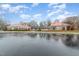 Community pool area featuring two red-roofed buildings separated by a gated swimming pool and parking at 702 Blue Lake Dr, Mebane, NC 27302