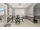 Bright dining room with a glass-top table, chandelier, and access to the patio at 702 Blue Lake Dr, Mebane, NC 27302