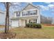 Traditional two-story home with a front-facing garage and well-maintained lawn at 702 Blue Lake Dr, Mebane, NC 27302