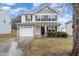 Lovely two-story home with a stone-accented garage and a well-kept lawn at 702 Blue Lake Dr, Mebane, NC 27302