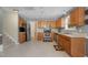 Well-lit kitchen with wood cabinets, stainless steel appliances, and tile flooring at 702 Blue Lake Dr, Mebane, NC 27302