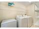 Functional laundry room features a washer, dryer, and convenient storage shelves at 702 Blue Lake Dr, Mebane, NC 27302