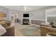Comfortable living area with a fireplace, TV, and open access to the dining room at 702 Blue Lake Dr, Mebane, NC 27302