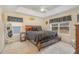 Bedroom with tray ceiling, ceiling fan, large windows, and a comfortable bed at 702 Blue Lake Dr, Mebane, NC 27302