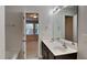 Bathroom featuring double sink vanity with dark wood cabinets and tub with shower at 7727 Weathered Oak Way, Raleigh, NC 27616