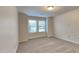 Simple and clean bedroom with two large windows, neutral carpet and paint at 7727 Weathered Oak Way, Raleigh, NC 27616