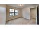 Cozy bedroom with a view, neutral carpet and a doorway visible at 7727 Weathered Oak Way, Raleigh, NC 27616