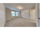 Neutral bedroom featuring plush carpeting, a window with blinds, and a closet door at 7727 Weathered Oak Way, Raleigh, NC 27616