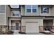 Inviting townhome with a well-manicured lawn, stone accents, and attached one car garage at 7727 Weathered Oak Way, Raleigh, NC 27616