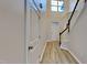 Bright foyer with soaring ceiling, light wood floors, staircase, and white paneled front door at 7727 Weathered Oak Way, Raleigh, NC 27616