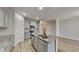 Modern kitchen with stainless appliances, granite counters, island with sink, and light gray cabinets at 7727 Weathered Oak Way, Raleigh, NC 27616