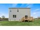 The back exterior of the home with a walk-out deck and spacious lawn at 78 Fair Child Rd, Spring Lake, NC 28390