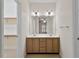 Bathroom features double sinks with wooden cabinets and large mirror at 800 Mill Greens Ct, Raleigh, NC 27609