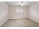 Simple carpeted bedroom with a ceiling fan and window with white shutters at 800 Mill Greens Ct, Raleigh, NC 27609