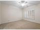 Simple carpeted bedroom with a ceiling fan and window with white shutters at 800 Mill Greens Ct, Raleigh, NC 27609