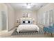 Stylishly staged bedroom with bed, lamps, artwork, ceiling fan, and windows with shutters at 800 Mill Greens Ct, Raleigh, NC 27609