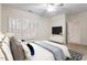 Furnished bedroom with bed, TV, dresser, ceiling fan, and sunlit windows with shutters at 800 Mill Greens Ct, Raleigh, NC 27609