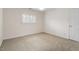 Bright bedroom featuring neutral carpet, walls, a ceiling fan, and a window at 800 Mill Greens Ct, Raleigh, NC 27609