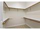 Walk-in closet with installed shelving and neutral carpet at 800 Mill Greens Ct, Raleigh, NC 27609