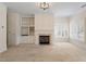 A living room with fireplace, built-in shelving, and plantation shutters, offering both style and functionality at 800 Mill Greens Ct, Raleigh, NC 27609