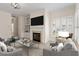 Bright living room with fireplace, built-ins, and plantation shutters; a cozy space for relaxation and entertaining at 800 Mill Greens Ct, Raleigh, NC 27609