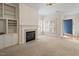 Inviting living room featuring a fireplace, built-in shelves, and natural lighting at 800 Mill Greens Ct, Raleigh, NC 27609
