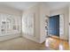 Bright living room featuring plantation shutters, hardwood floors, and a modern blue front door at 800 Mill Greens Ct, Raleigh, NC 27609
