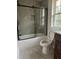 Modern bathroom featuring a glass shower door, tile surround, and tiled floor at 812 Kenmore Ave, Louisburg, NC 27549