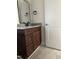 Bathroom view features stylish vanity with dark wood cabinets and granite countertop at 812 Kenmore Ave, Louisburg, NC 27549