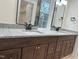 Bathroom showcasing double vanity with dark wood cabinets and granite countertops at 812 Kenmore Ave, Louisburg, NC 27549