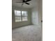 Carpeted bedroom with neutral paint and large windows at 812 Kenmore Ave, Louisburg, NC 27549