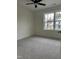 Bright bedroom featuring gray carpet, neutral walls, and a window offering natural light at 812 Kenmore Ave, Louisburg, NC 27549