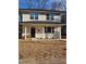 Charming two-story home with a covered porch and manicured front lawn at 812 Kenmore Ave, Louisburg, NC 27549